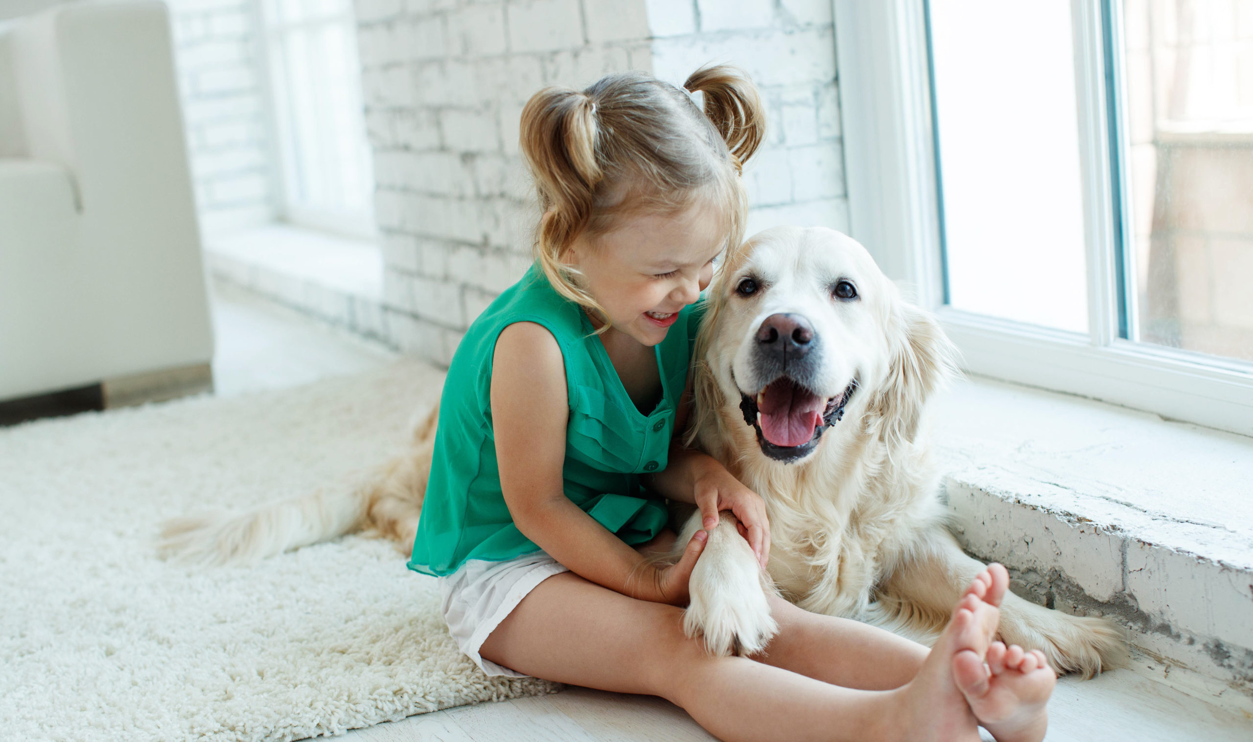 Young girl cuddling with her dog